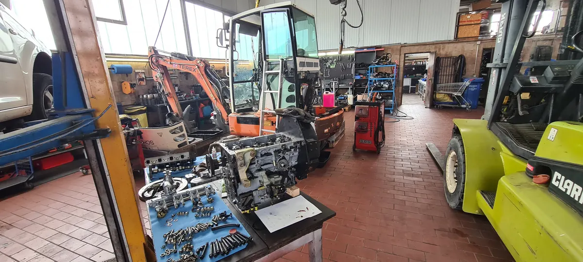 Dismantled engine with individual parts on the workshop bench